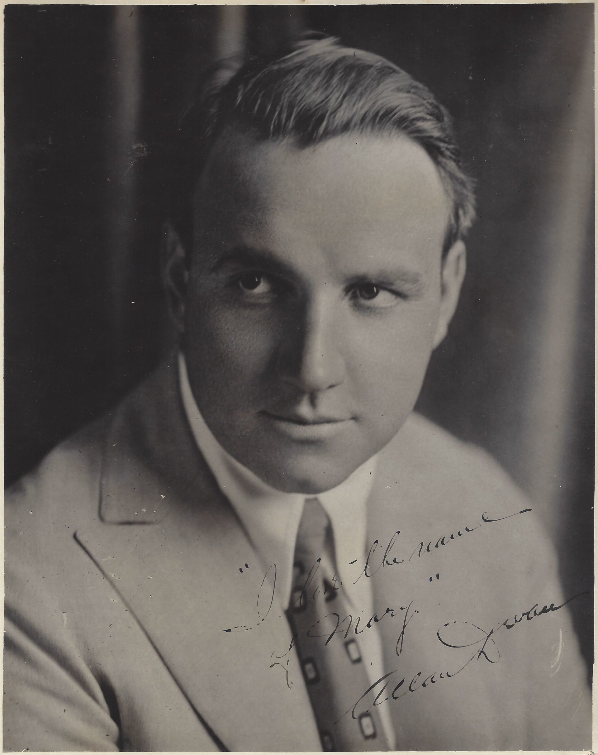 A vintage portrait of director Allan K. Warren with a signature, highlighting careers in film.