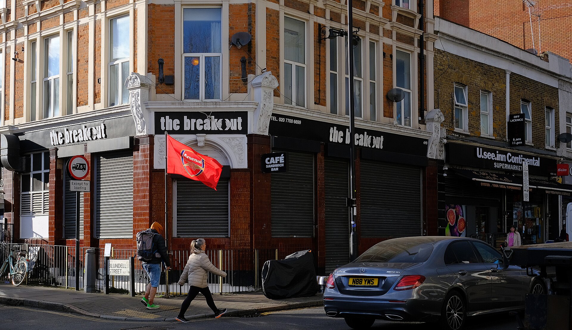 A London street shows shops and a pedestrian, illustrating the challenges faced during early careers in film.